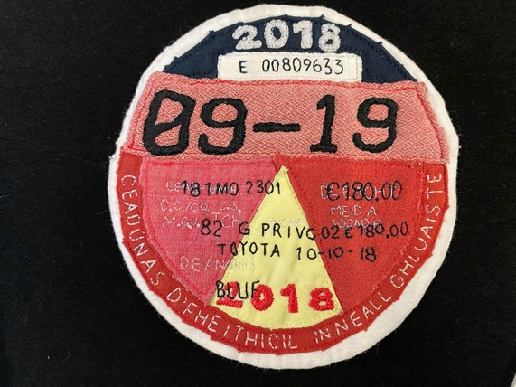 “Tax Disc” by Megan Herring • Size: 4 x 4” Material: Cotton, batting, stabilizer, thread